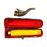 A cased 9ct gold mounted amber cigarette holder, L. 7.5cms, and small cigar cutter.
