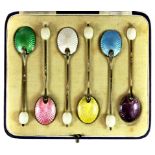 A cased set of six enamelled silver coffee spoons.