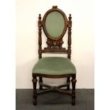 A 19th century carved oak hall chair.