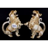 A pair of 19th century German porcelain griffin jugs, one A/F, H. 18cm.
