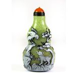 An attractive Chinese carved Peking cameo glass three layer snuff bottle with gilt and orange