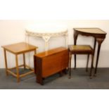 A group of five small occasional tables.