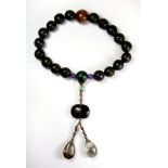 A string of unusual Tibetan carved wood, glass and rock crystal prayer beads.