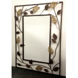 A contemporary iron wall mirror, W. 66cm, H. 86cm.