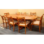 A good quality extending dining table and eight chairs, open L. 238cm.