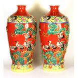 A pair of impressive mid 20th century Chinese relief decorated porcelain vases, H. 56cm.