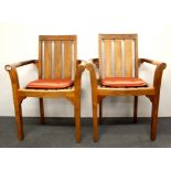 A pair of heavy quality teak conservatory chairs with cushions.