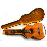 A cased Tatra classical guitar.