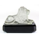 An early 20th century frosted crystal figure of a lion on a black glass base, H. 7.5cm.