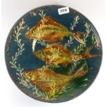 A signed glazed pottery bowl decorated with fish, Dia. 34cm.