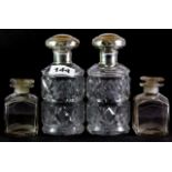 A pair of silver and cut glass dressing table bottles, (H. 15cm), together with a pair of further