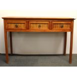 A contemporary teak three drawer side table, W. 110cm, H. 75cm.