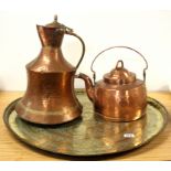 A large eastern hammered brass tray with a large copper kettle and copper jug, tray Dia. 72cm.