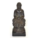 A Chinese carved hardwood figure of a Buddha seated on an elevated lotus throne, H. 19cm.