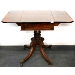 A 19th century Regency style pedestal drop leaf tea table.