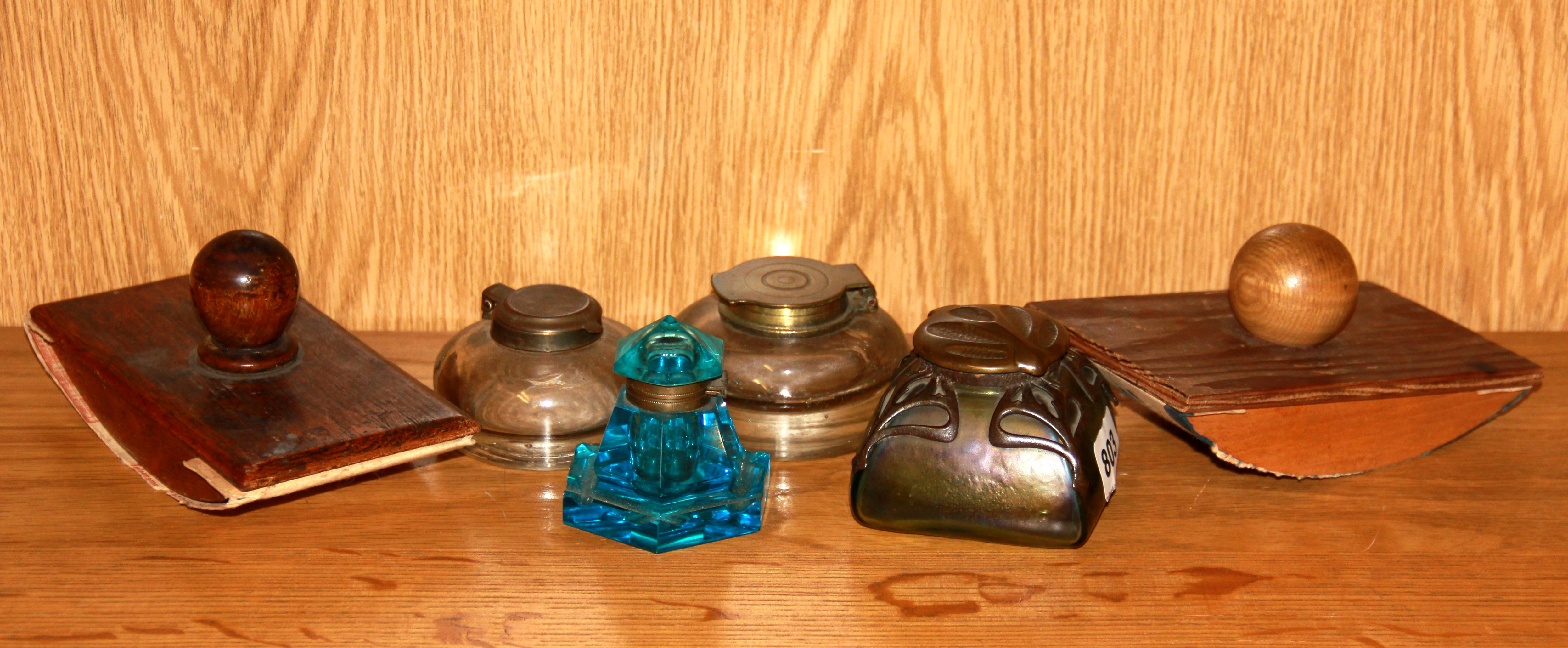 An Art Nouveau inkwell, three further inkwells and two blotters.