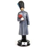 A Michael Sutty hand painted porcelain figure (no. 49) of a soldier in the Irish Guards. H. 32cm.