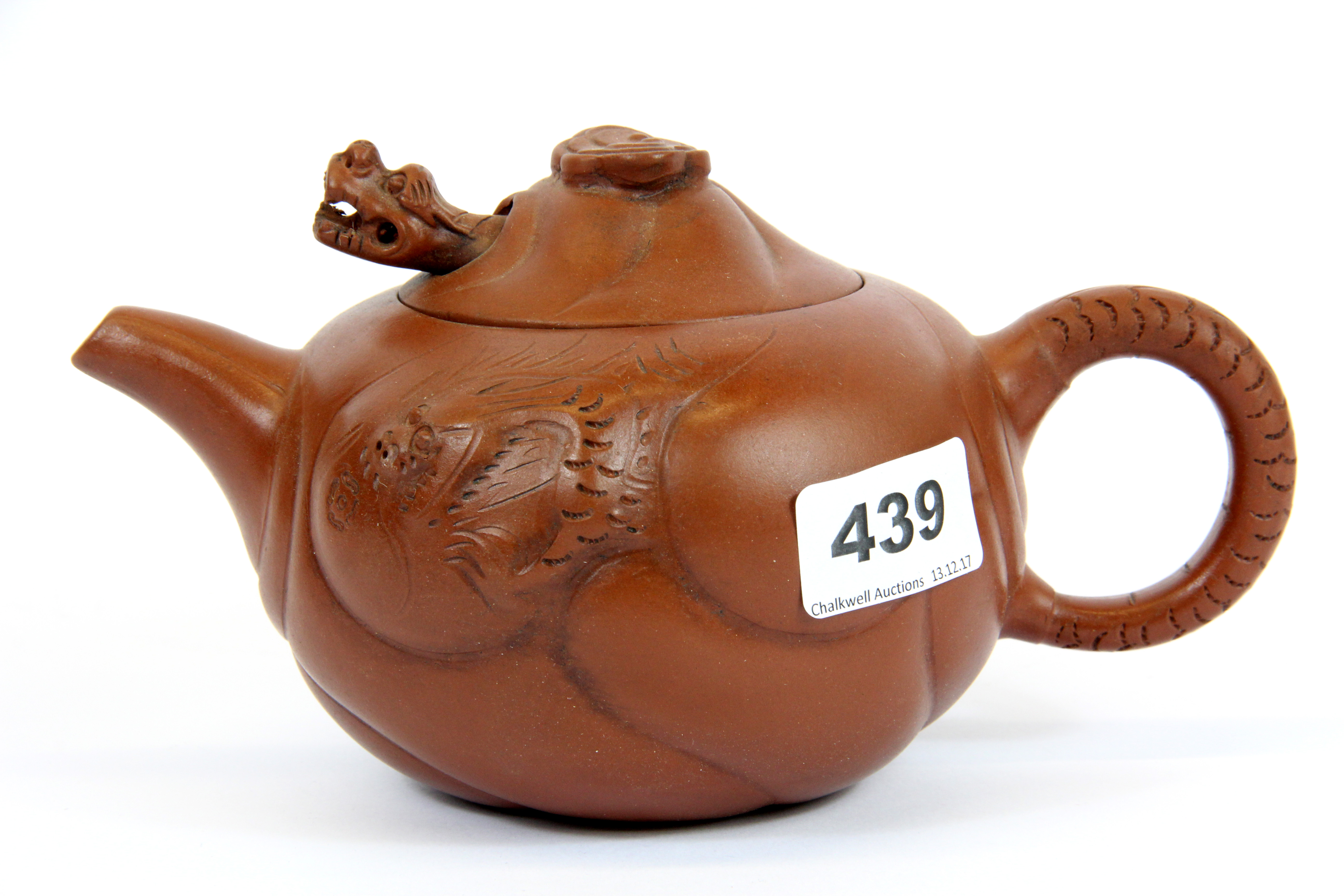 A Chinese handmade Yixing terracotta teapot with dragon decoration and articulated dragon head in