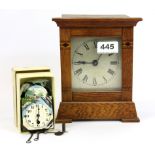 A miniature enamelled alpine wall clock and an inlaid oak mantle clock.