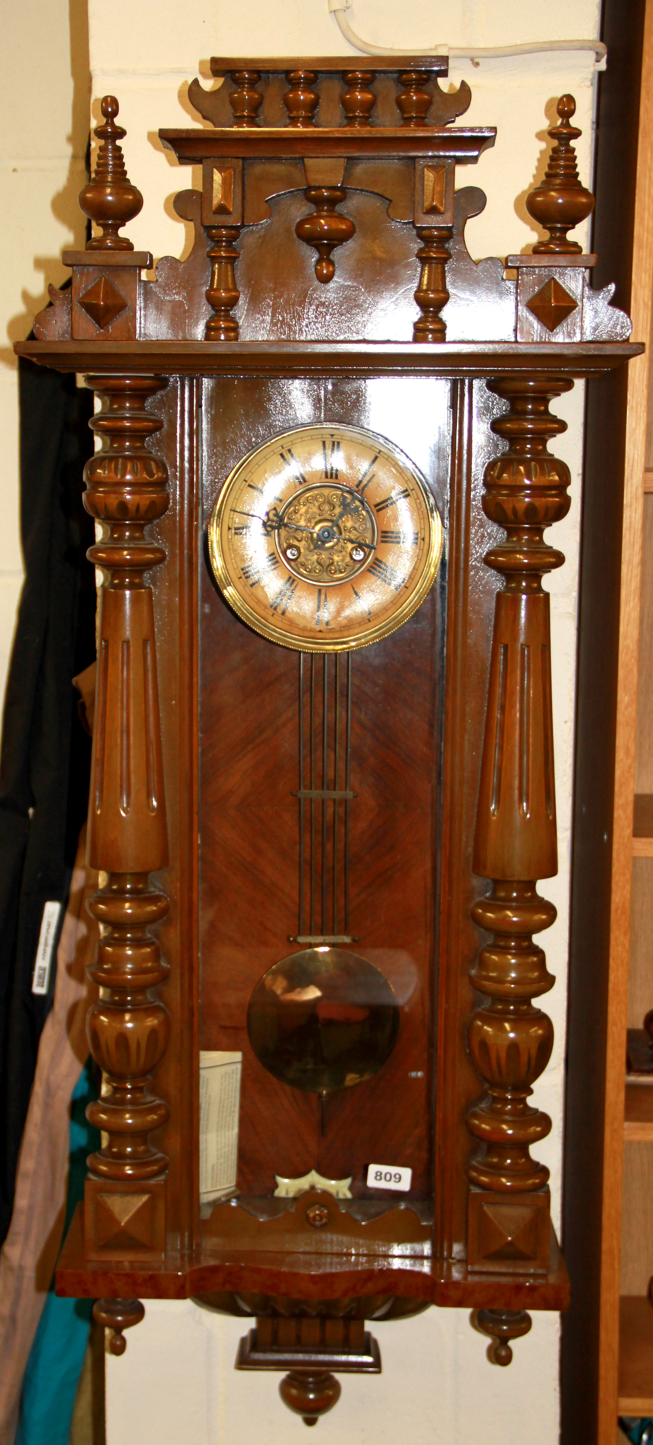 A 19th century Vienna style wall clock, L. 124cm.