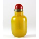 A Chinese Imperial yellow glass snuff bottle with gilt and faux coral stopper, H. 7.5cm.