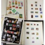 Three albums of world stamps with a quantity of additional pages.