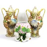 Two ornate continental porcelain vases with lids and a porcelain cherub centre piece, jar H. 40cm.