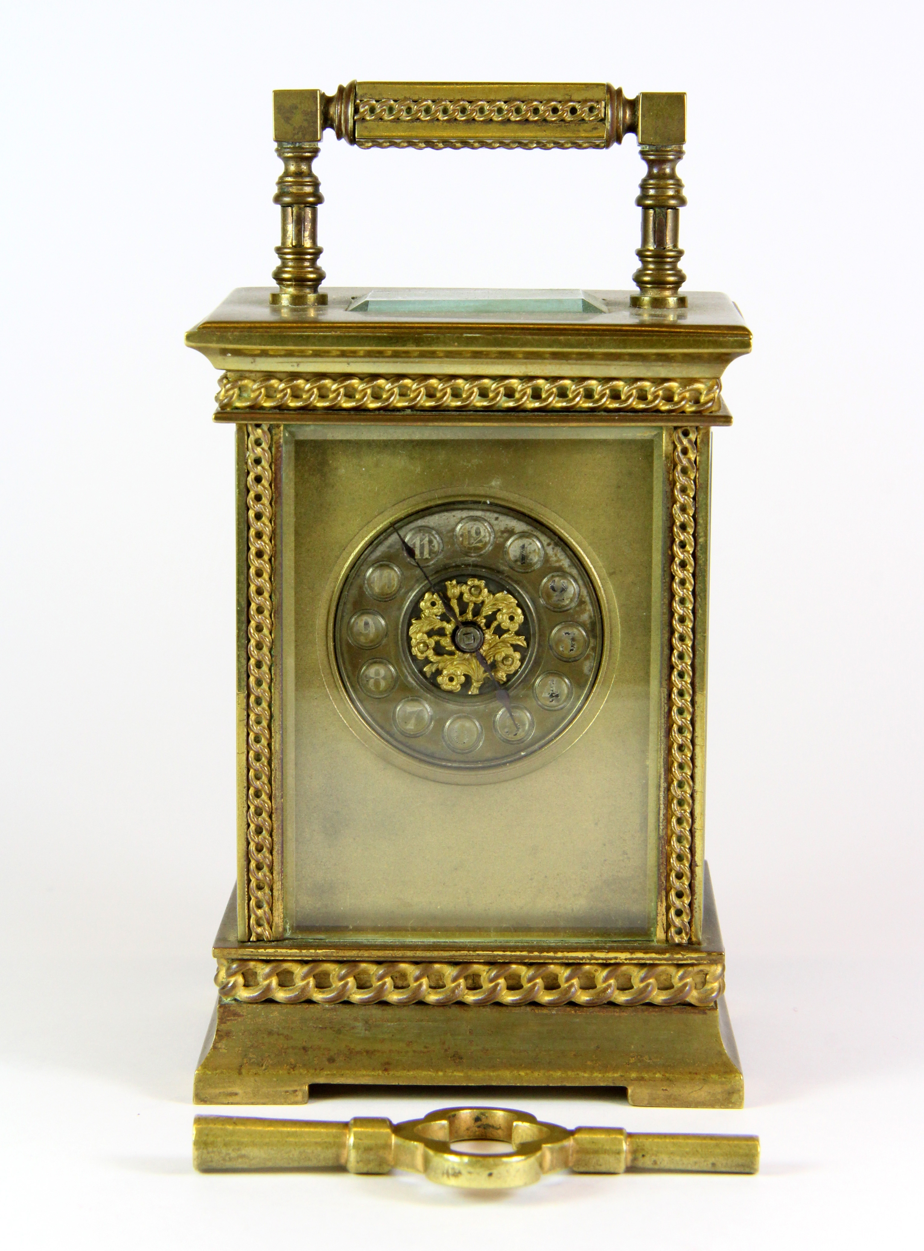 An early 20th century French gilt brass carriage clock with key, H. 14cm.