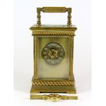 An early 20th century French gilt brass carriage clock with key, H. 14cm.