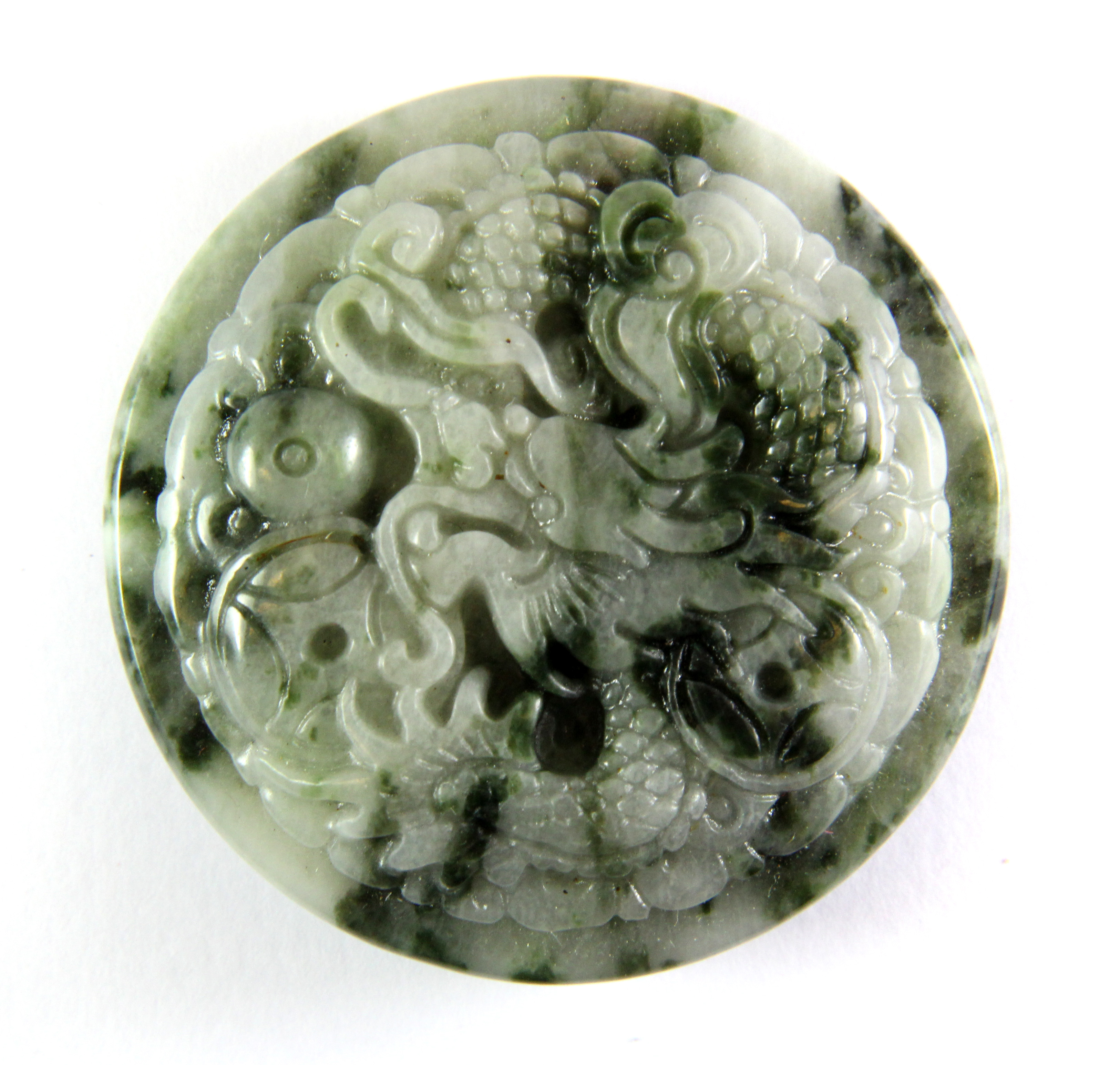 A Chinese mixed colour jade dragon buckle, Dia. 5.5cm.