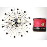 A vintage starburst wall clock and a vintage Smiths Dulcet wall clock.