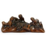 An unusual mid 20thC Chinese carved root wood brush rest, L. 22cm, H. 9cm.