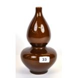 A 19th century Chinese brown glazed gourd shaped porcelain vase, six character mark to base, H.