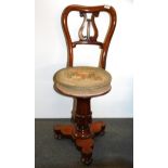 An early 19th century tapestry upholstered revolving adjustable harpist's chair.