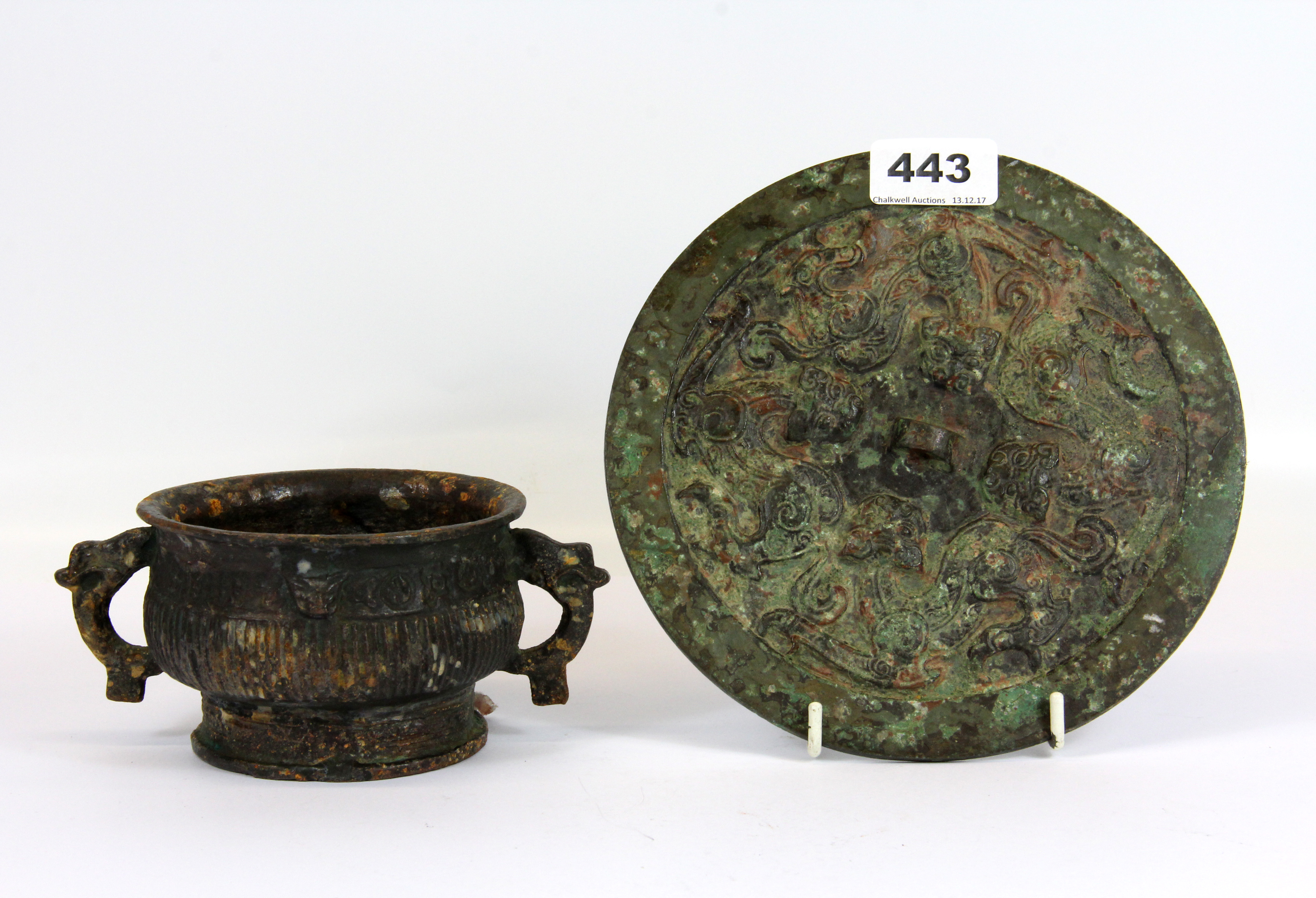 A Chinese Ming Dynasty form bronze hand mirror and cast iron censer, Dia. 19cm.