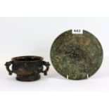 A Chinese Ming Dynasty form bronze hand mirror and cast iron censer, Dia. 19cm.