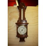 A 19th century carved oak aneroid barometer, H. 92cm.