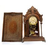 A 19th century American mantle clock and a carved wooden tray.