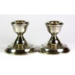 A pair of small hallmarked silver candlesticks, H. 7cm.