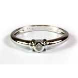 A 9ct white gold diamond solitaire ring, (P).