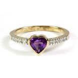 A 9ct yellow gold ring set with a heart shaped amethyst and diamond set shoulders, (P.5).