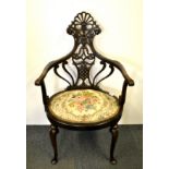 An Edwardian carved and upholstered armchair, back H. 97cm.