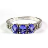 A 9ct white gold tanzanite and diamond set ring, (O.5).