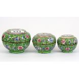 A nest of three early 20th century Chinese Canton enamelled boxes, largest Dia. 9cm, H. 5.6cm.