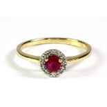 A 9ct yellow gold ruby and diamond halo ring, (O.5).