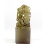 A mid 20th century Chinese carved grey soapstone seal mounted with a boy on an elephant, H. 8cm.
