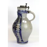 A large German Mettlach pottery jug with pewter lid, H. 40cm.