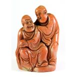 A mid 20th century Chinese carved hardstone seal of the Happy Buddha with an attendant, H. 11cm.
