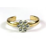 A 9ct yellow gold stone set flower shaped adjustable toe ring.