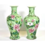 A lovely pair of Chinese hand enamelled celadon glazed porcelain vases, six character mark to